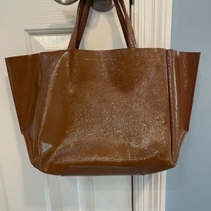 Ampersand and Apostrophe shiny brown leather bag with small snap in zipper pouch